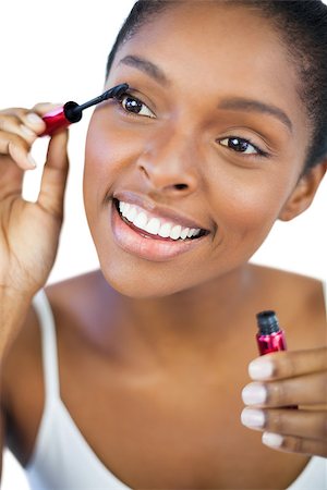 simsearch:400-06890736,k - Happy woman using mascara for her eyelashes on white background Stock Photo - Budget Royalty-Free & Subscription, Code: 400-06890746