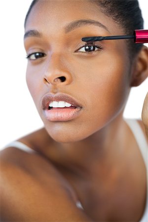 simsearch:400-06890736,k - Young woman using mascara for her eyelashes on white background Stock Photo - Budget Royalty-Free & Subscription, Code: 400-06890748