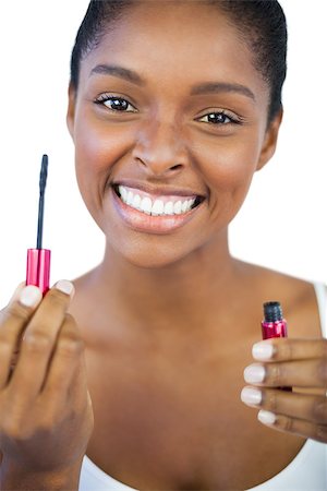simsearch:400-06890736,k - Smiling woman showing her mascara on white background Stock Photo - Budget Royalty-Free & Subscription, Code: 400-06890749