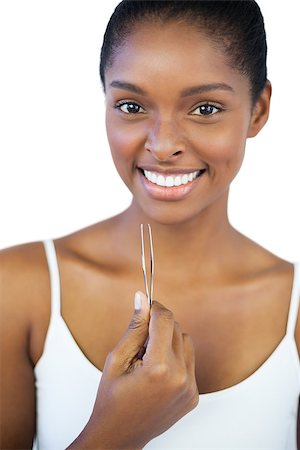 simsearch:400-06890736,k - Smiling woman holding her tweezers on white background Stock Photo - Budget Royalty-Free & Subscription, Code: 400-06890755