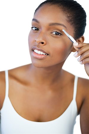 simsearch:400-06890736,k - Young woman using her tweezers on white background Stock Photo - Budget Royalty-Free & Subscription, Code: 400-06890756