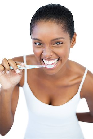 simsearch:400-06890736,k - Smiling woman brushing her teeth on white background Stock Photo - Budget Royalty-Free & Subscription, Code: 400-06890777