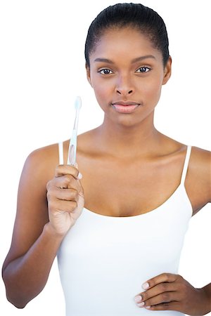 simsearch:400-06890736,k - Woman with hand on hip holding her toothbrush on white background Stock Photo - Budget Royalty-Free & Subscription, Code: 400-06890771