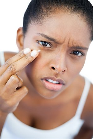 simsearch:400-06890736,k - Unsmiling woman putting moisturizer on her face on white background Stock Photo - Budget Royalty-Free & Subscription, Code: 400-06890783