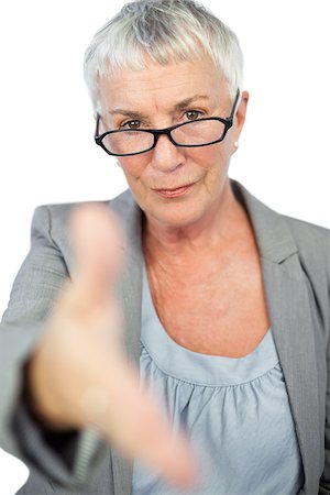 Serious woman with glasses presenting her hand for handshake on white background Stock Photo - Budget Royalty-Free & Subscription, Code: 400-06890834