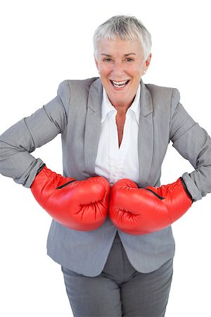 portrait of woman wearing boxing gloves - Cheerful businesswoman wearing boxing gloves on white background Stock Photo - Budget Royalty-Free & Subscription, Code: 400-06890897