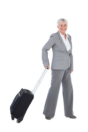 Smilling businesswoman with her luggage on white background Stock Photo - Budget Royalty-Free & Subscription, Code: 400-06890901