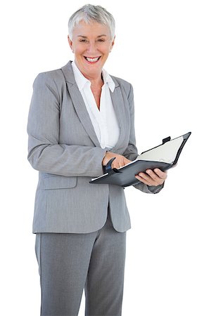 Smiling businesswoman holding her diary on white background Stock Photo - Budget Royalty-Free & Subscription, Code: 400-06890947