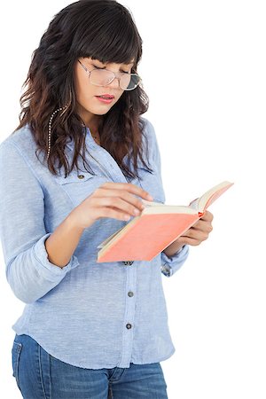 Brunette wearing glasses and reading her book on white background Stock Photo - Budget Royalty-Free & Subscription, Code: 400-06891010