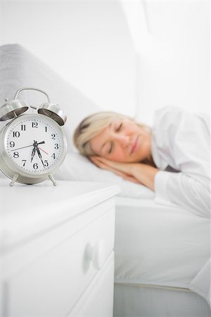 Blonde woman asleep in bed before her alarm clock goes off Stock Photo - Budget Royalty-Free & Subscription, Code: 400-06891078