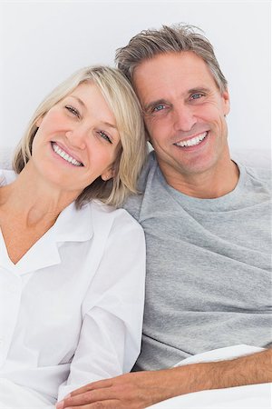 simsearch:400-06891126,k - Content couple in bed smiling at camera Stock Photo - Budget Royalty-Free & Subscription, Code: 400-06891113