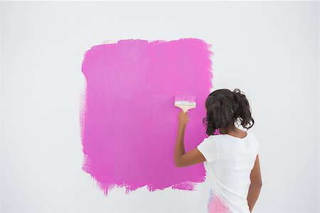 Young woman painting her wall in pink in new home Stock Photo - Budget Royalty-Free & Subscription, Code: 400-06891546
