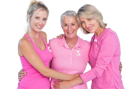 simsearch:400-06870717,k - Happy women wearing pink tops and ribbons for breast cancer on white background Stock Photo - Budget Royalty-Free & Subscription, Code: 400-06891587