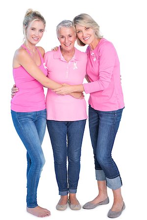 Cheerful women wearing pink tops and ribbons for breast cancer on white background Stock Photo - Budget Royalty-Free & Subscription, Code: 400-06891589