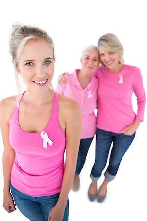 simsearch:400-06870717,k - Three women wearing pink tops and breast cancer ribbons on white background Stock Photo - Budget Royalty-Free & Subscription, Code: 400-06891594