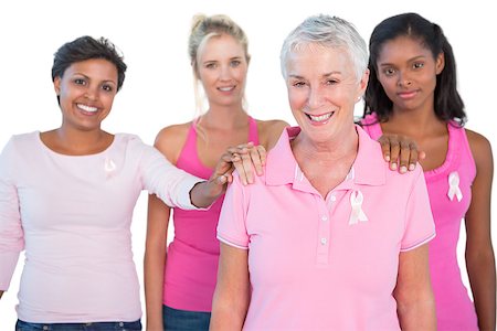 Supportive group of women wearing pink tops and breast cancer ribbons on white background Stock Photo - Budget Royalty-Free & Subscription, Code: 400-06891598