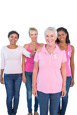 Supportive women wearing pink tops and breast cancer ribbons on white background Stock Photo - Budget Royalty-Free & Subscription, Code: 400-06891599
