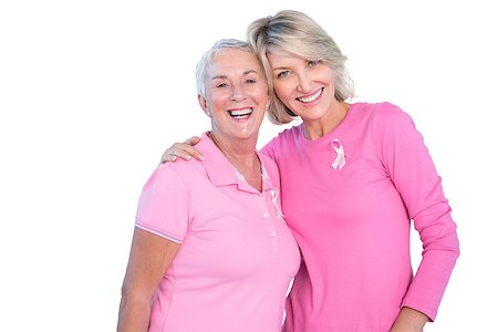 simsearch:400-06870717,k - Mature women wearing pink tops and ribbons for breast cancer on white background Stock Photo - Budget Royalty-Free & Subscription, Code: 400-06891591