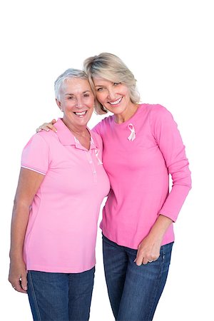 Mature women wearing pink tops and breast cancer ribbons on white background Foto de stock - Super Valor sin royalties y Suscripción, Código: 400-06891592