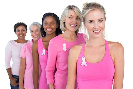 Smiling women wearing pink and ribbons for breast cancer on white background Foto de stock - Super Valor sin royalties y Suscripción, Código: 400-06891619