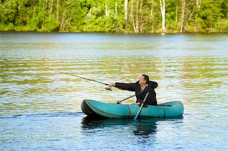 simsearch:400-06852239,k - man fishing in rubber boat on a lake Photographie de stock - Aubaine LD & Abonnement, Code: 400-06891711