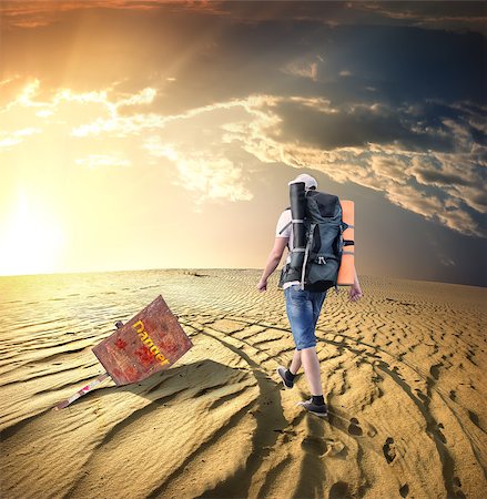 picture of thirsty man in desert - Man with a backpack traveling in the desert Stock Photo - Budget Royalty-Free & Subscription, Code: 400-06892082