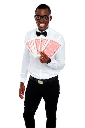 A man holding up a few playing cards isolated against white background Stock Photo - Budget Royalty-Free & Subscription, Code: 400-06914876