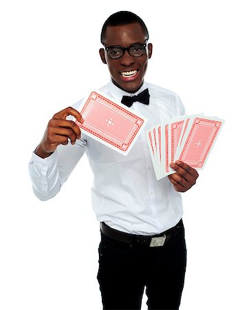 Young black boy holding out deck of cards and throwing his trump card Stock Photo - Budget Royalty-Free & Subscription, Code: 400-06914879
