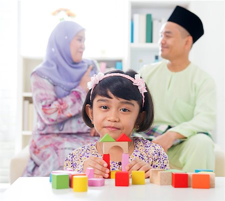 Malay girl building a wooden toy house. Southeast Asian family at home. Muslim parents and child living lifestyle. Stock Photo - Budget Royalty-Free & Subscription, Code: 400-06915016