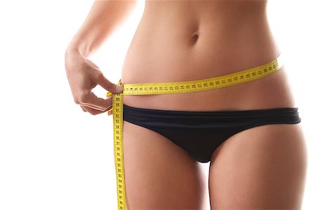 simsearch:614-06168638,k - young woman dieting and contemplating weight loss measuring waist with tape on white background Stockbilder - Microstock & Abonnement, Bildnummer: 400-06915010