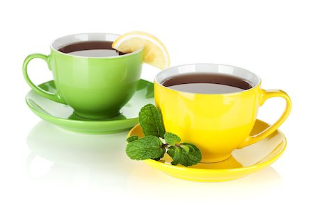 simsearch:400-04476908,k - Two colorful cups of tea with lemon and mint. Isolated on white background Stock Photo - Budget Royalty-Free & Subscription, Code: 400-06915179