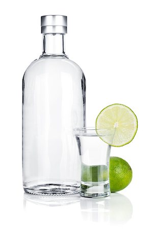 Bottle of vodka and shot glass with lime slice. Isolated on white background Stock Photo - Budget Royalty-Free & Subscription, Code: 400-06915364