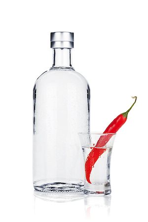 simsearch:400-06914551,k - Bottle of vodka and shot glass with red chili pepper. Isolated on white background Stock Photo - Budget Royalty-Free & Subscription, Code: 400-06915362