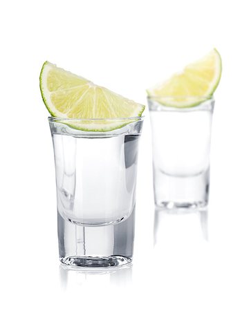simsearch:400-06914551,k - Two shots of vodka and lime slice. Isolated on white background Stock Photo - Budget Royalty-Free & Subscription, Code: 400-06915376