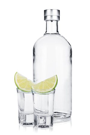 simsearch:400-06914551,k - Bottle of vodka and shot glasses with lime slice. Isolated on white background Stock Photo - Budget Royalty-Free & Subscription, Code: 400-06915392