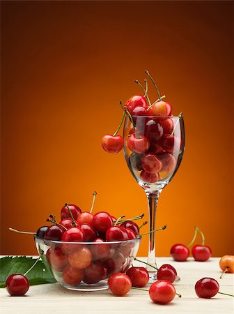 tasty fresh and ripe red cherry in the glass on wooden table Stock Photo - Budget Royalty-Free & Subscription, Code: 400-06915673