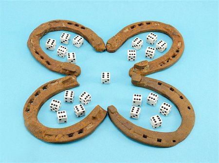 concept of four leaf clover made of rusty retro horse shoes and six number gamble dices on blue background. luck talisman. Stock Photo - Budget Royalty-Free & Subscription, Code: 400-06916769