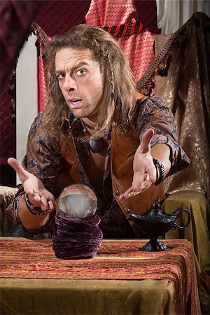 fortune teller (male) - Cute man with crystal ball and open hands Stock Photo - Budget Royalty-Free & Subscription, Code: 400-06916828
