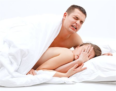 Young, naked couple in bed, the man leaning over the woman Stock Photo - Budget Royalty-Free & Subscription, Code: 400-06917109