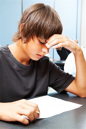 Teen boy taking an objective test in school and worried about the outcome. Stock Photo - Budget Royalty-Free & Subscription, Code: 400-06917330