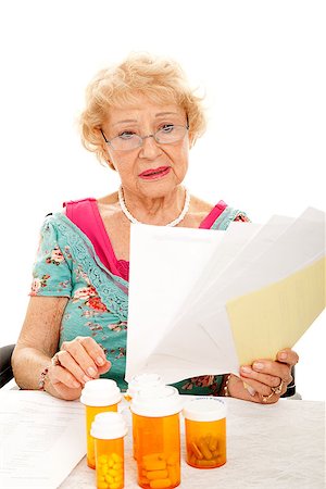 sad grandmother - Disabled senior lady in wheelchair holding a pile of medical bills.  White background. Stock Photo - Budget Royalty-Free & Subscription, Code: 400-06917368