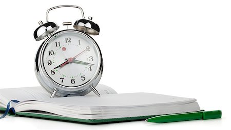 simsearch:400-05163997,k - Alarm clock on notepad. Isolated on white background Stock Photo - Budget Royalty-Free & Subscription, Code: 400-06917556