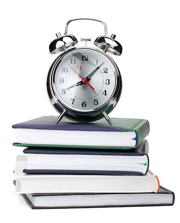 simsearch:400-04293721,k - Alarm clock on notepads and books. Isolated on white background Fotografie stock - Microstock e Abbonamento, Codice: 400-06917551