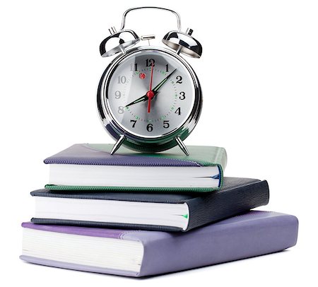 simsearch:400-04293721,k - Alarm clock on notepads and books. Isolated on white background Fotografie stock - Microstock e Abbonamento, Codice: 400-06917552