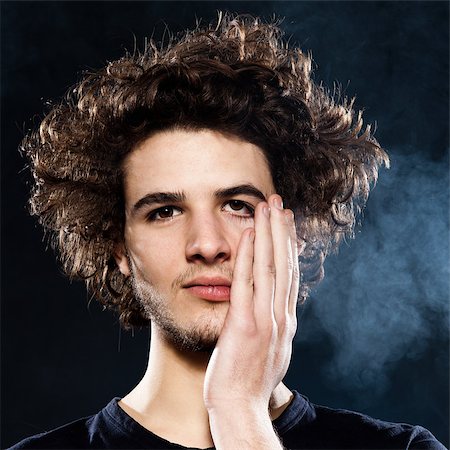 resaca - studio portrait of a cool young man on black background Foto de stock - Super Valor sin royalties y Suscripción, Código: 400-06917793