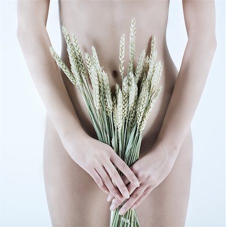 female human gastrointestinal system - studio shot picture of a young beautiful breast naked caucasian woman holding grain Stock Photo - Budget Royalty-Free & Subscription, Code: 400-06917883