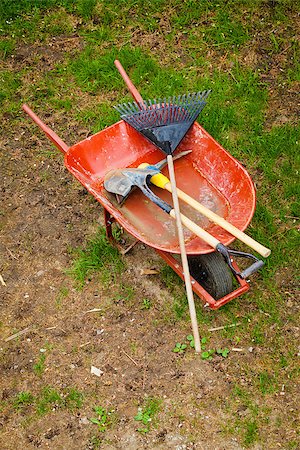 simsearch:400-06175558,k - Old Wheelbarow with axepick, shovel and rake Stock Photo - Budget Royalty-Free & Subscription, Code: 400-06918143