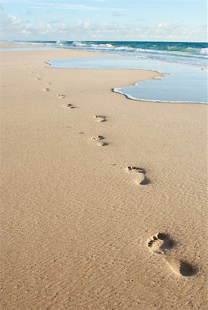 Human footprints on the beach sand leading away from the viewer Stock Photo - Budget Royalty-Free & Subscription, Code: 400-06919041