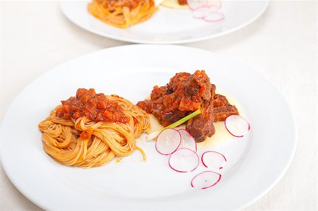 simsearch:400-08115563,k - traditional Italian spaghetti pasta with pork ribbs sauce served on polenta bed Photographie de stock - Aubaine LD & Abonnement, Code: 400-06919306