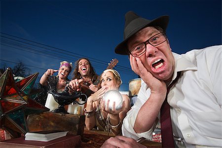 simsearch:400-06561343,k - Embarrassed white businessman next to giggling fortune teller Stock Photo - Budget Royalty-Free & Subscription, Code: 400-06919563
